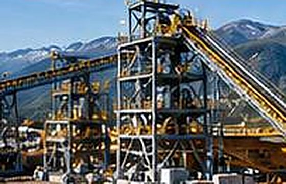 Mine site processing structures and conveyors below mountains